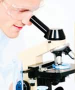 smiling man researching on a microscope