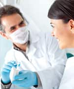 Dentist showing how to brush teeth