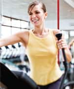 Woman exercising on elliptical machine