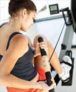 rear view of a woman exercising on a rowing machine