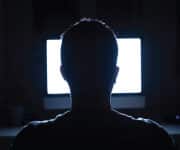 Man using computer - Use of cellphones and other mobile devices exposes users to blue light, which suppresses melatonin levels and disrupts circadian rhythms, resulting in sleep disturbances.