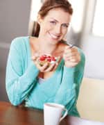 Woman eating bowl of yogurt