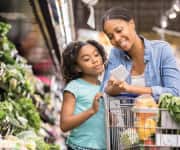 Woman and child looking at grocery list