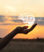 Image of a hand with a floating brain