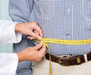 Man having abdomen measured