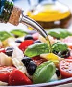 Olive oil being poured over salad