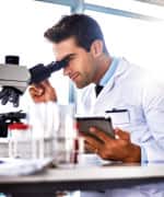 Man looking into a microscope