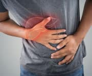 man clutching his abdomen