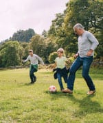 Family playing soccer