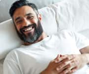 Man laying down smiling.