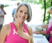 Woman showing breast cancer ribbon