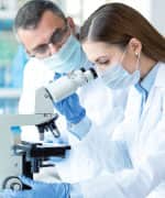 Scientist looking in a microscope