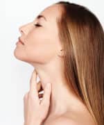 Woman touching her neck