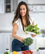 Woman holding cruciferous vegetables