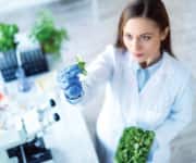 A scientist looking at vegetables
