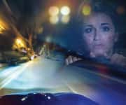 Woman driving at night