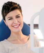 Woman smiling after eye exam