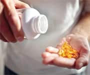 man taking Omega-3 supplements