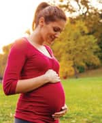 pregnant woman looking at belly