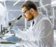 Man looking into microscope