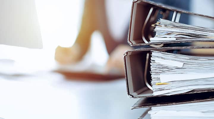 FDA worker with three document binders of other delayed therapies