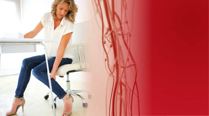 Woman in chair clutching her leg from venous thromboembolisms