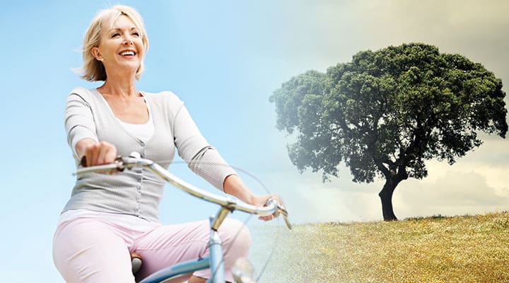 Smiling woman on bike being supported by bark extract