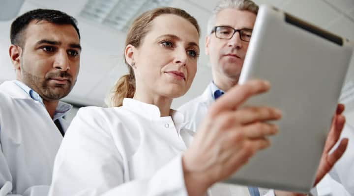 Doctors reading study on total bioavailable testosterone for aging men