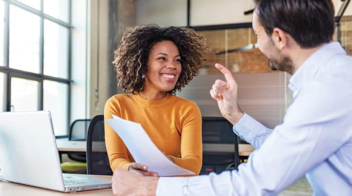 Coworkers talking about project through increased clarity and energy