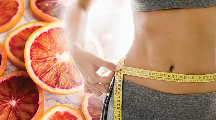 Woman measuring her waist circumference for decreasing belly fat
