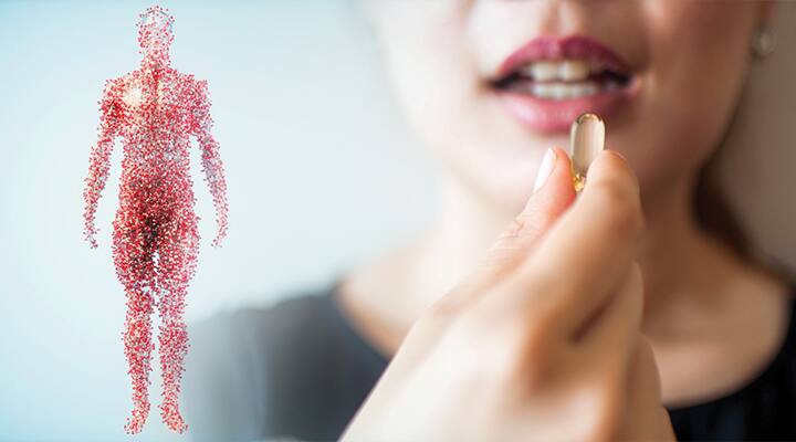 Woman taking supplement composed of bioavailable plant extracts
