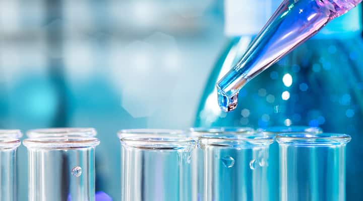 Lab testing of cancer treatment in multiple test tubes and dropper