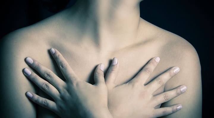 Topless woman checking herself for fibrocystic breast changes