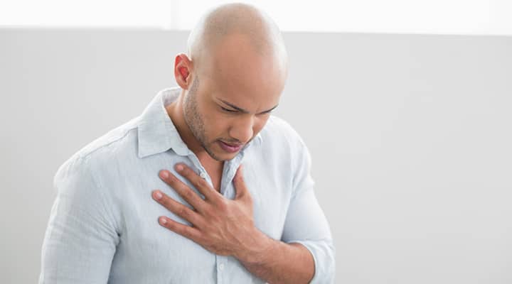 Man experiencing discomfort due to gastroesophageal reflux