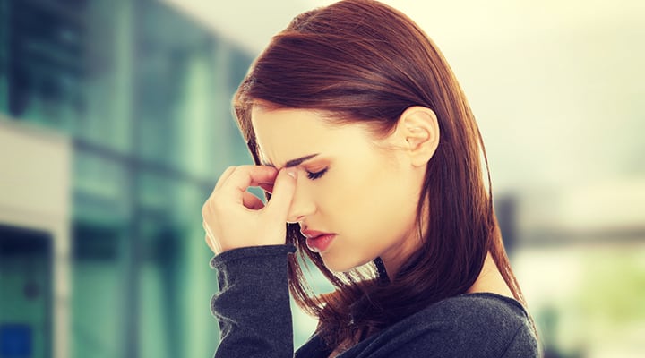 Woman pressing on her nose due to inflammation from sinusitis