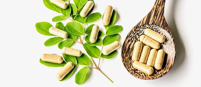 Vitamins on leaf and spoon