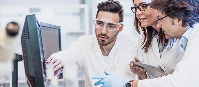 Scientists looking at computer screen