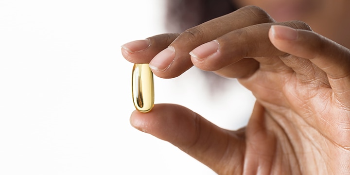 Hand holding vitamin