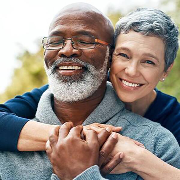 Old healthier couple holding hands