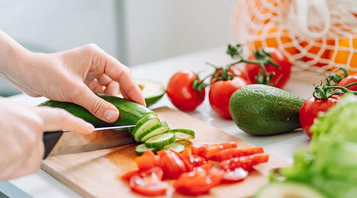 Man chopping cucumbers