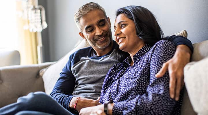 Man and woman sitting on a couch at home