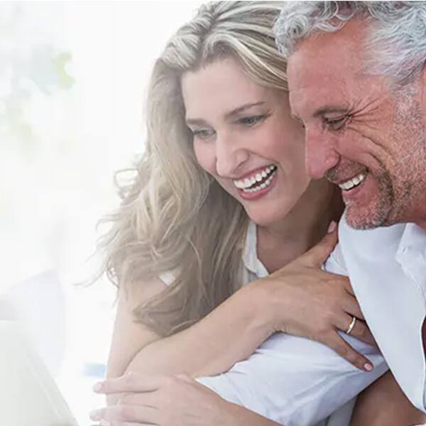 Couple look at a laptop