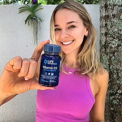 Our Customers in their own words. Woman hold a bottle of life extension vitamin d.