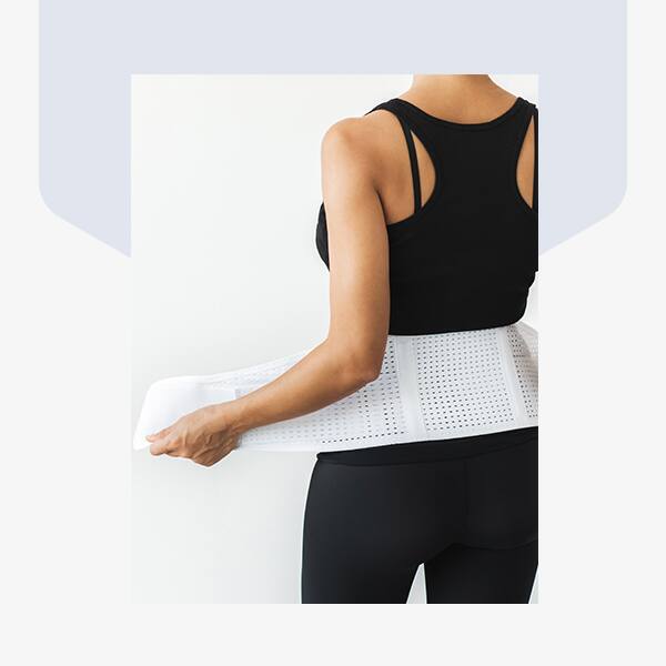 A lady adjusting his corset