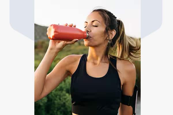 Woman drinking water after a work out