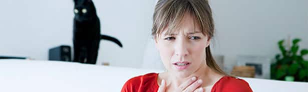 Woman having allergic reaction from cat