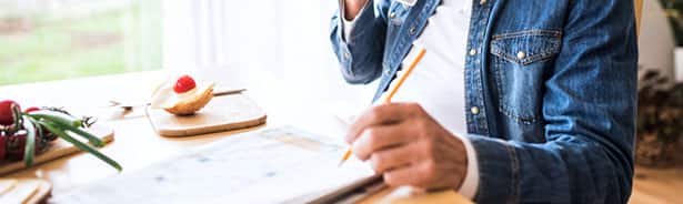 Older man writing to measure neurological disorder risk