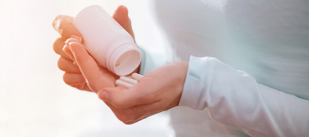 Woman with Vitamin D supplements