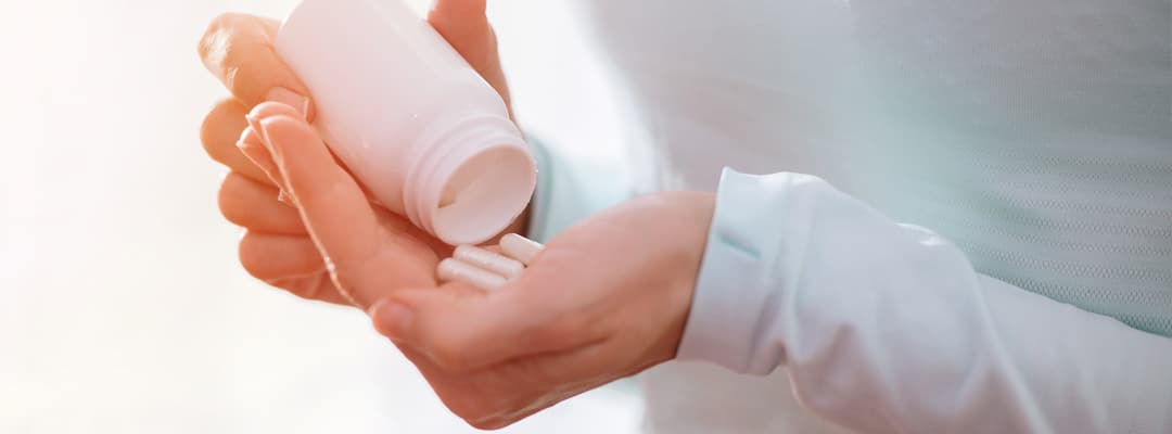 Woman with Vitamin D supplements