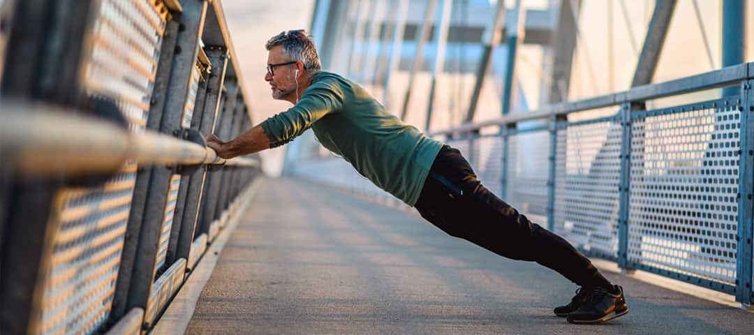 Man working out on a bridge boardwalk